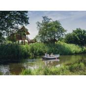 Beautiful wooden tree house with terrace in a holiday park on the river De Regge
