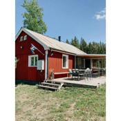 Luxurious red cottage with wood stove near lake
