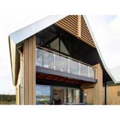 Modern design lodge on the water located on a holiday park in a national park