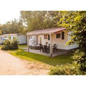 Nice chalet with covered terrace at a holiday park on the Leukermeer