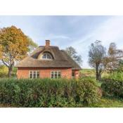 thatched cottage with tiled stove