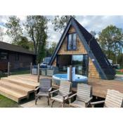 Widgeon Bespoke Cabin is lakeside with Private fishing peg, hot tub situated at Tattershall Lakes Country Park